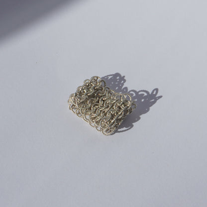 Handcrafted wide mesh ring made of interlinked twisted silver loops