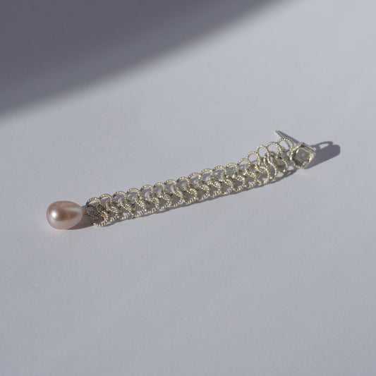 Handcrafted silver earring with lace-like chain, freshwater pearl, and hand-set gemstone