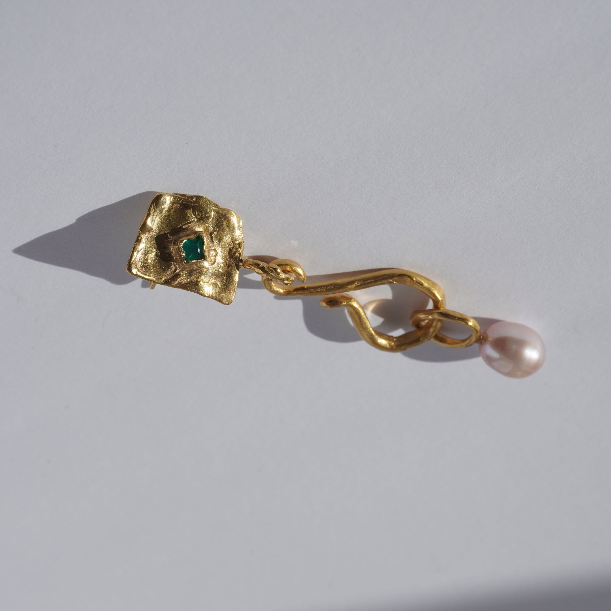 Gold-plated handcrafted earring with organic sculptural element, green hand-set gemstone, and freshwater pearl