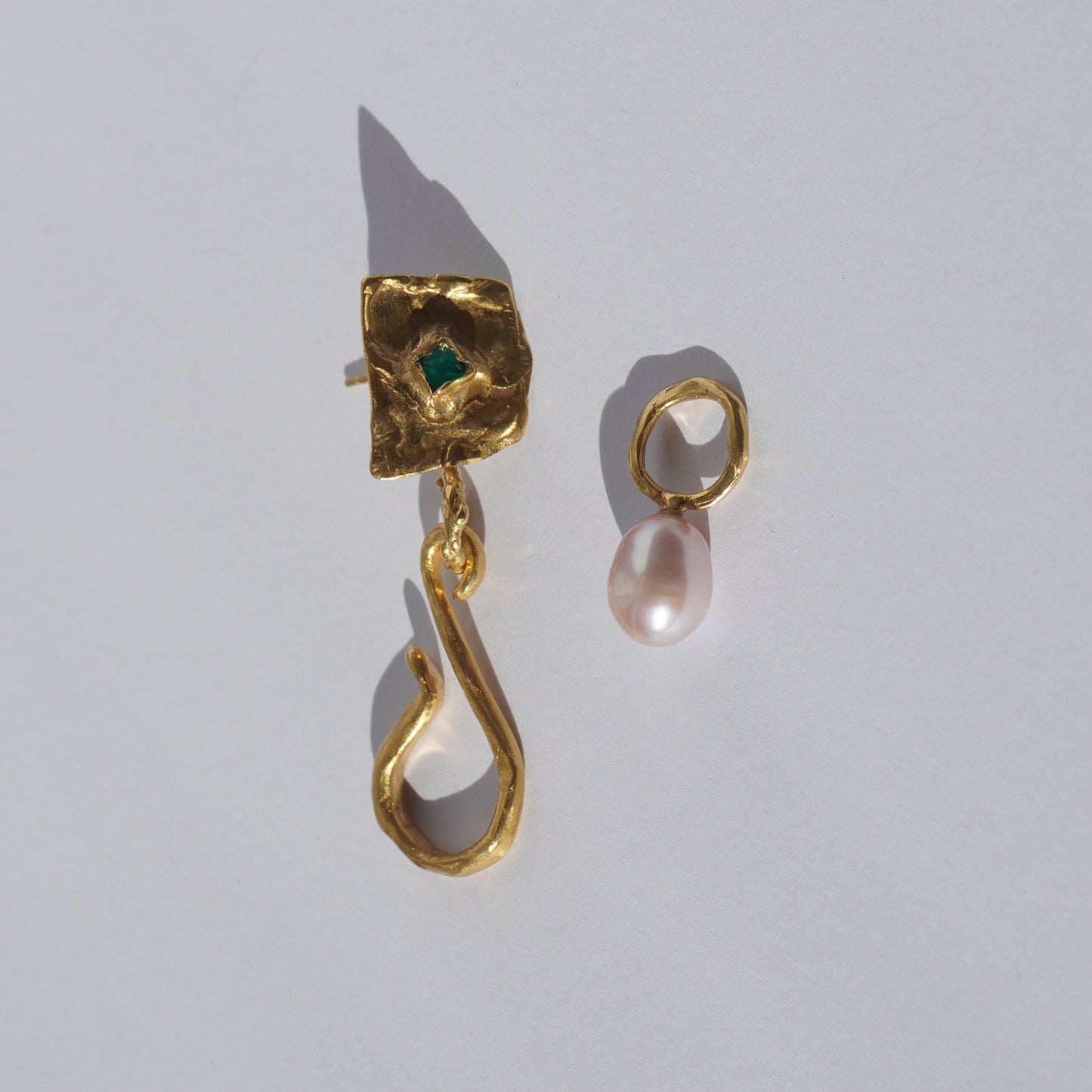 Gold-plated handcrafted earring with organic sculptural element, green hand-set gemstone, and freshwater pearl