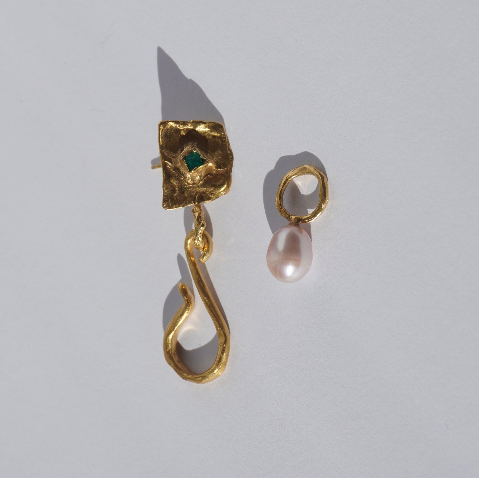 Gold-plated handcrafted earring with organic sculptural element, green hand-set gemstone, and freshwater pearl