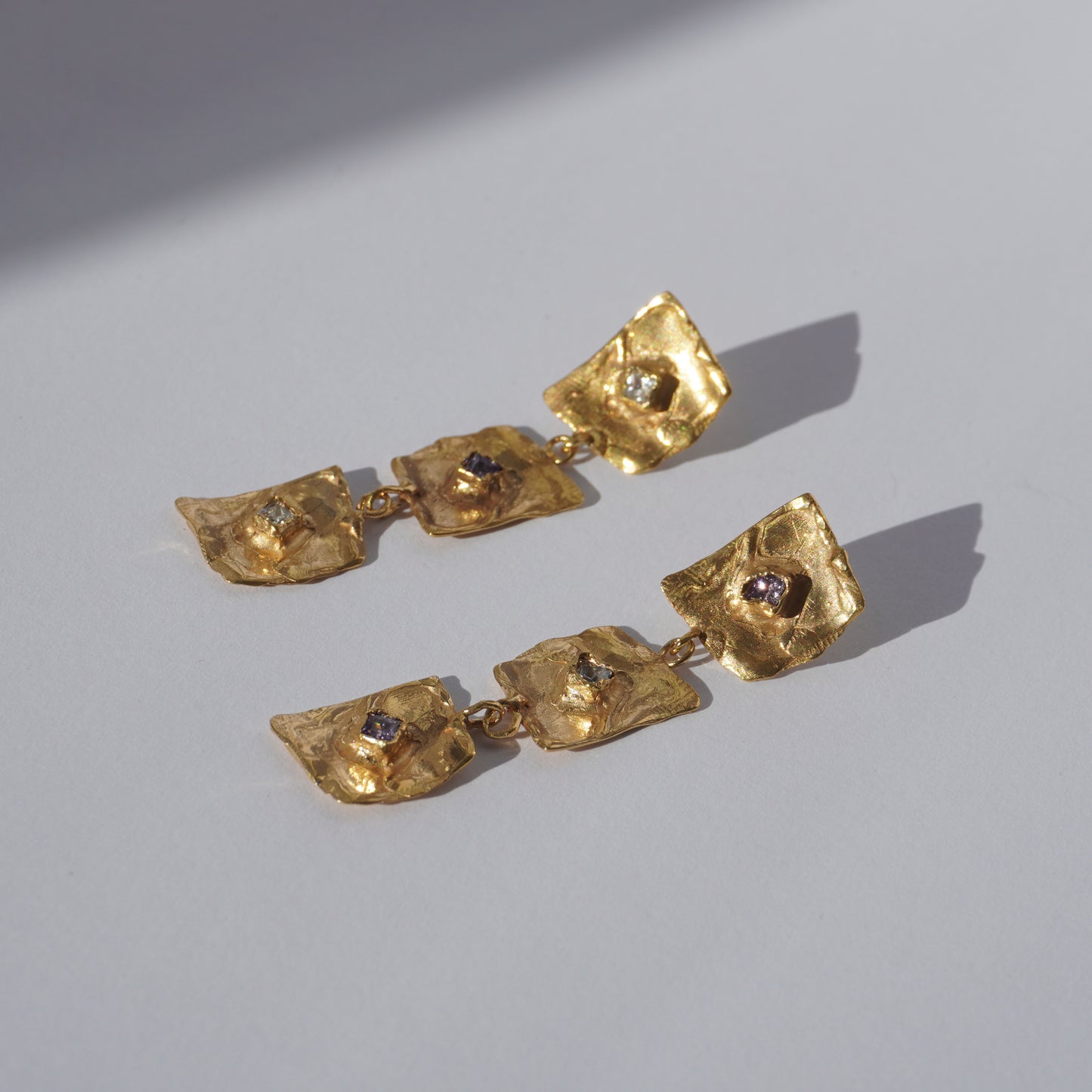 Gold-plated handcrafted earrings with organic sculptural elements and hand-set gemstones