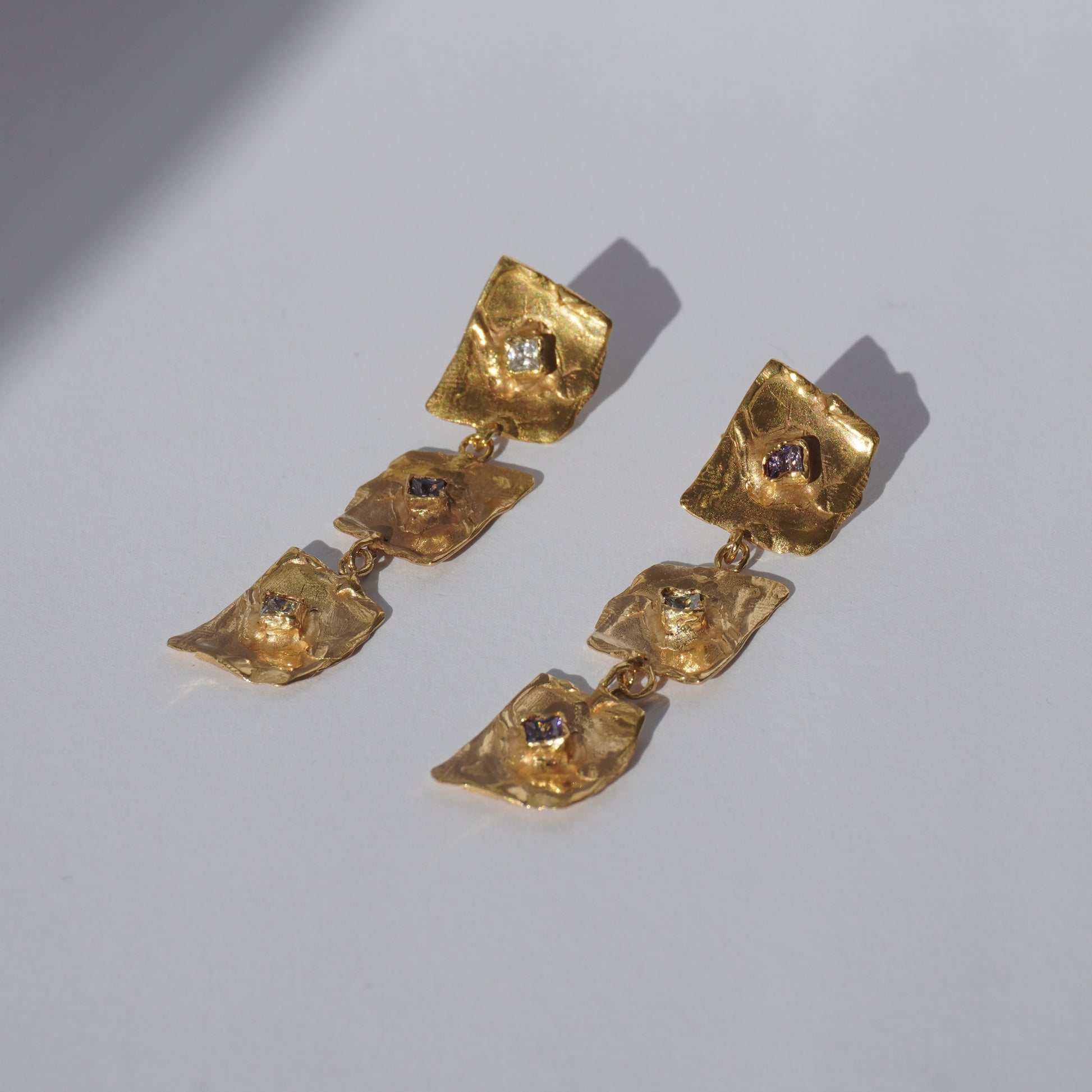 Gold-plated handcrafted earrings with organic sculptural elements and hand-set gemstones