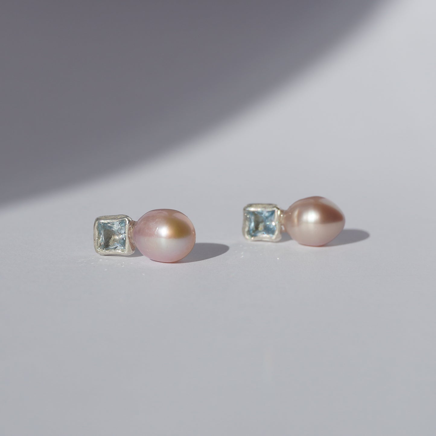 Handcrafted silver earrings with square light-blue gemstones and pink freshwater pearls