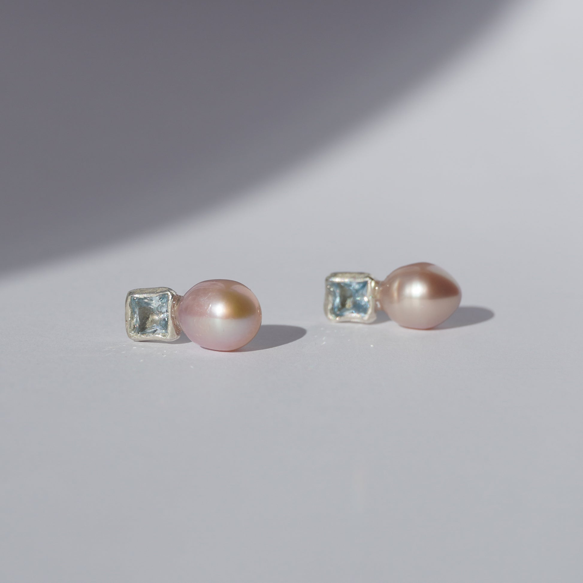 Handcrafted silver earrings with square light-blue gemstones and pink freshwater pearls
