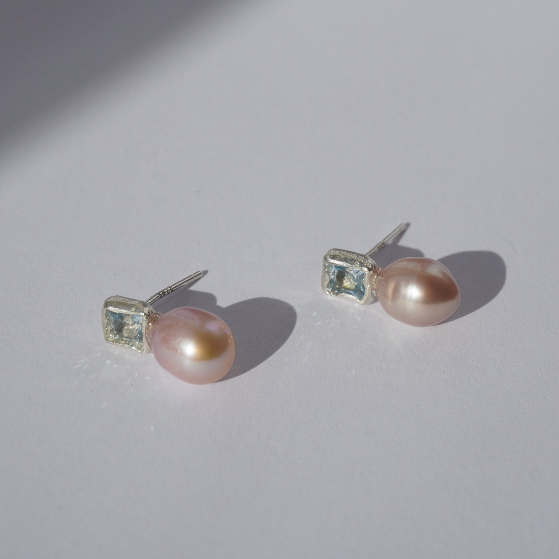 Handcrafted silver earrings with square light-blue gemstones and pink freshwater pearls