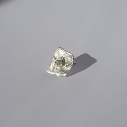 Silver handcrafted stud earrings with organic sculptural surfaces and green hand-set gemstones