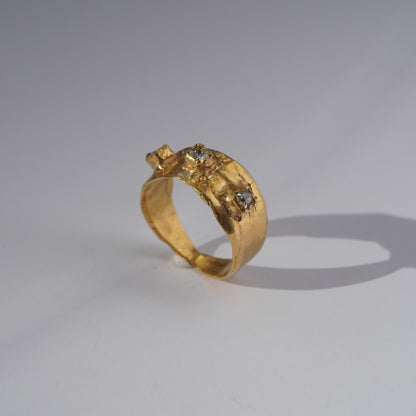 Handcrafted gold ring with organic sculpted band and three set gemstones