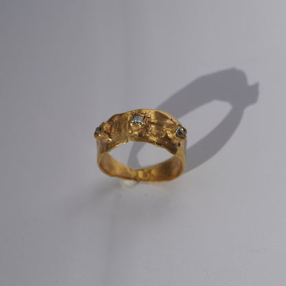 Handcrafted gold ring with organic sculpted band and three set gemstones