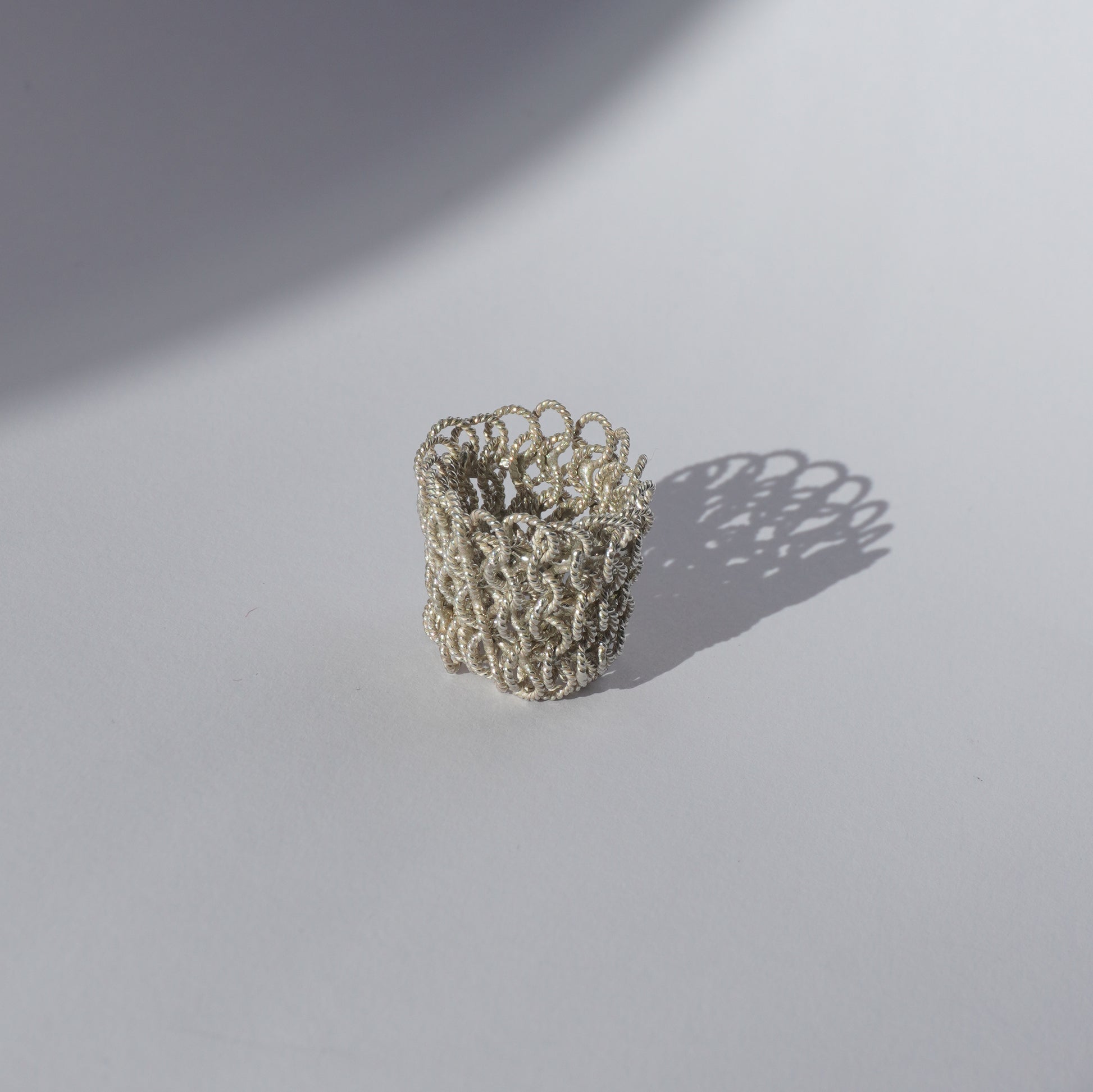 Handcrafted wide mesh ring made of interlinked twisted silver loops