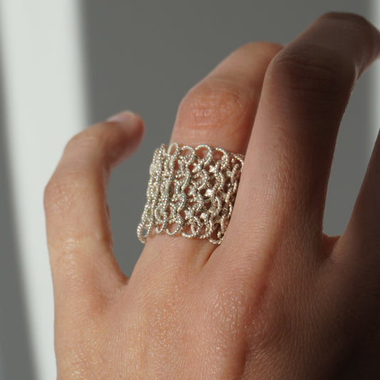 Handcrafted wide mesh ring made of interlinked twisted silver loops