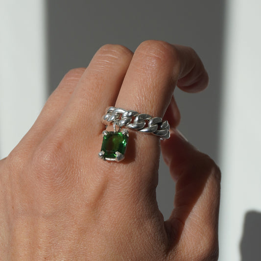 Handcrafted silver ring with twisted band and hanging emerald-cut green gemstone