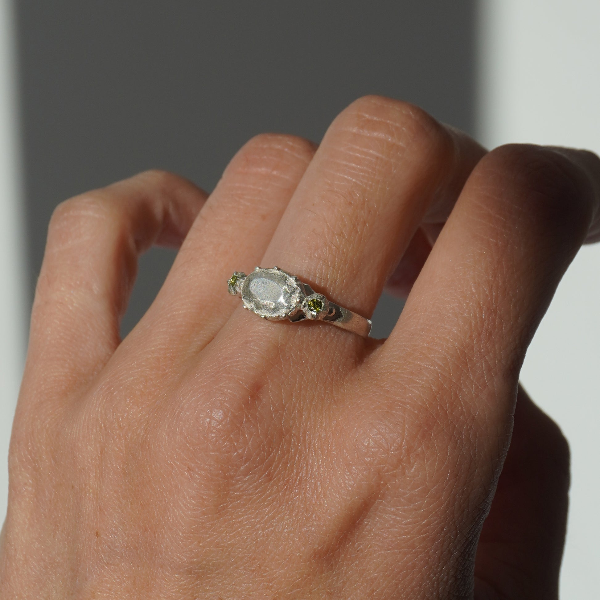 Handcrafted silver ring with organic oval centerpiece and sculpted details