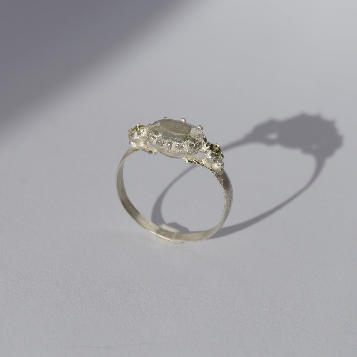 Handcrafted silver ring with organic oval centerpiece and sculpted details