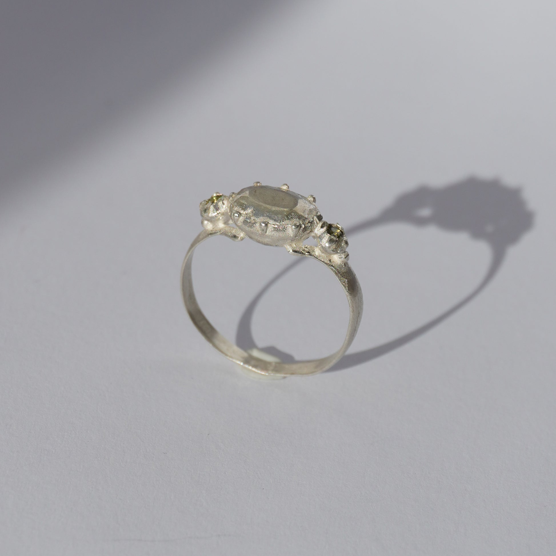 Handcrafted silver ring with organic oval centerpiece and sculpted details