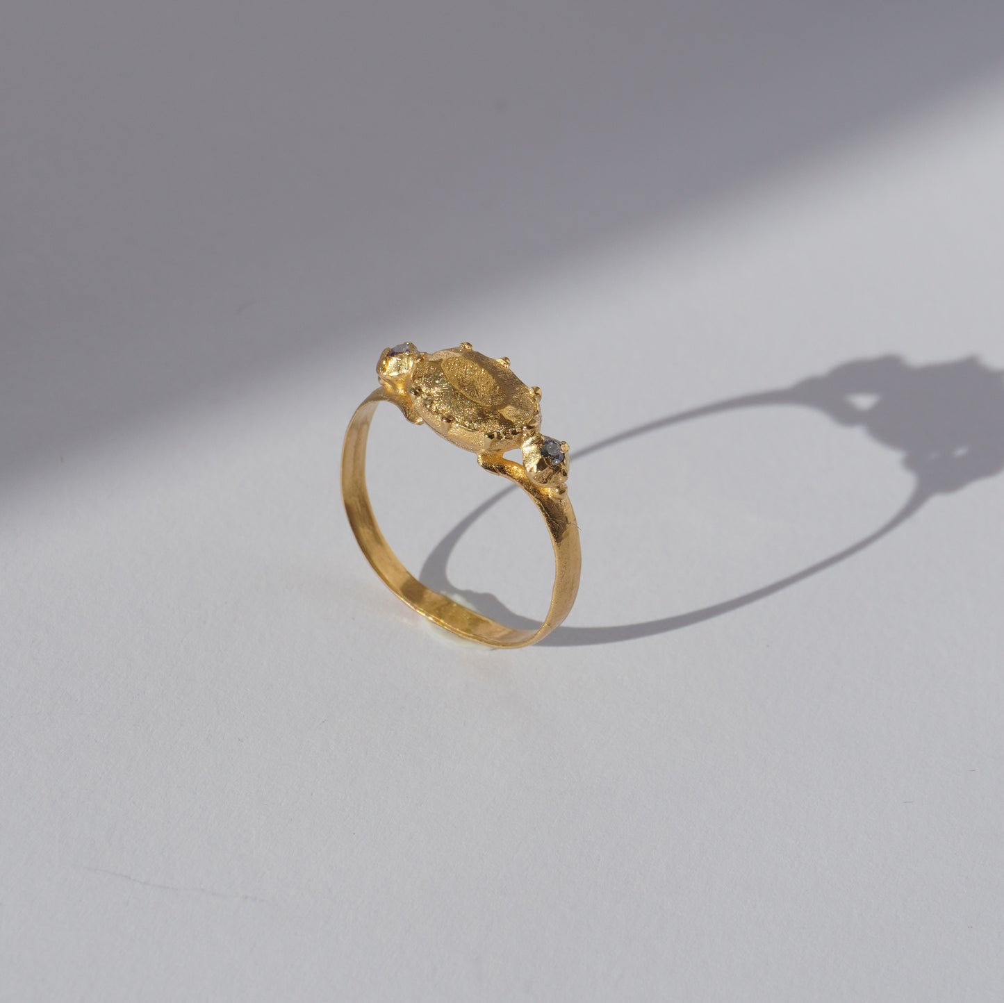 Handcrafted gold-plated ring with organic oval centerpiece and sculpted details