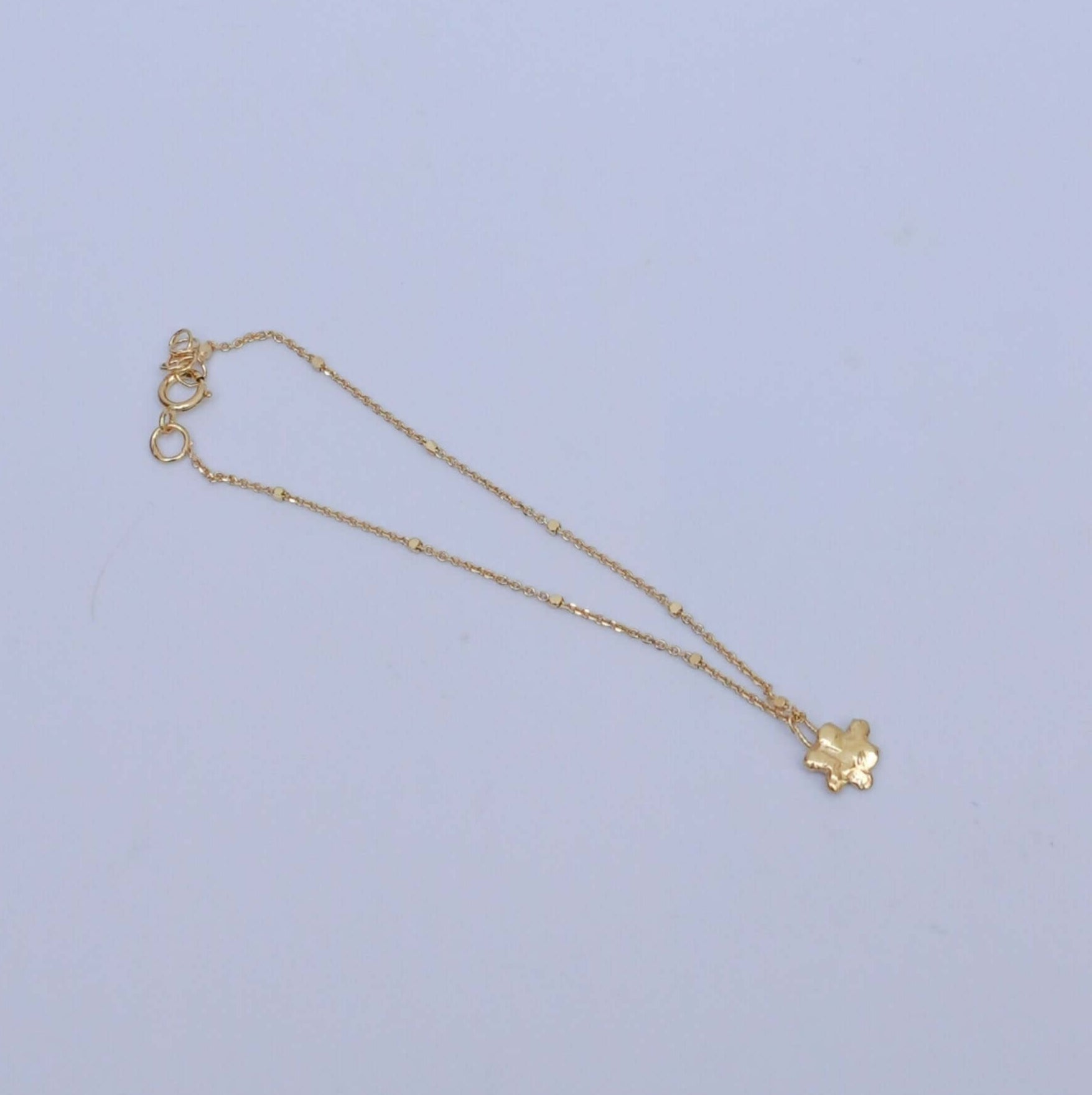 Handmade gold-plated silver bracelet with little flower pendant