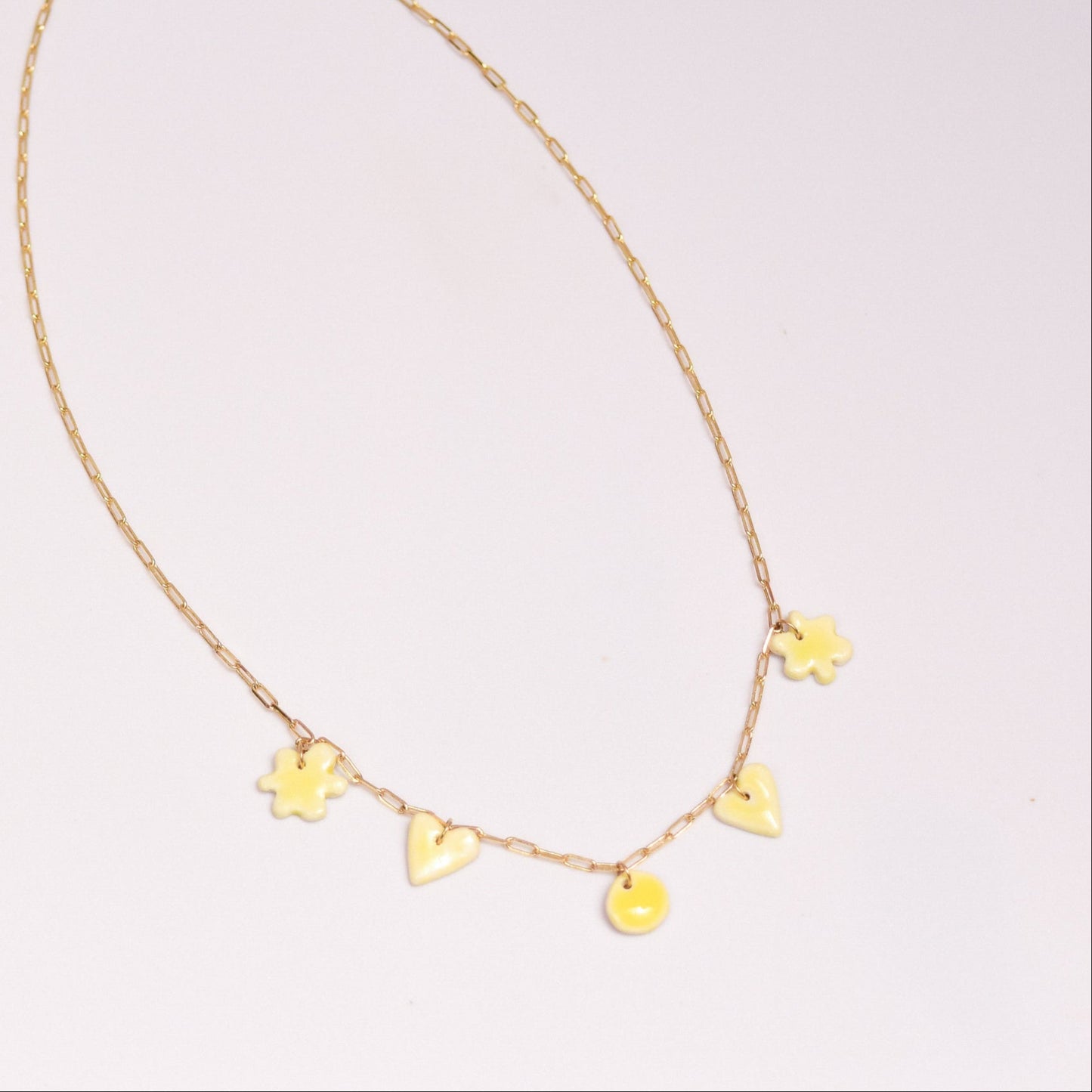 Gold plated chain with handmade yellow porcelain pendants.