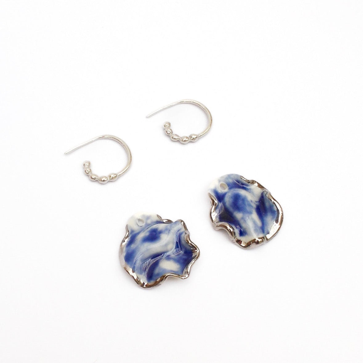 Resilience hoop porcelain earrings blue with silver luster detail