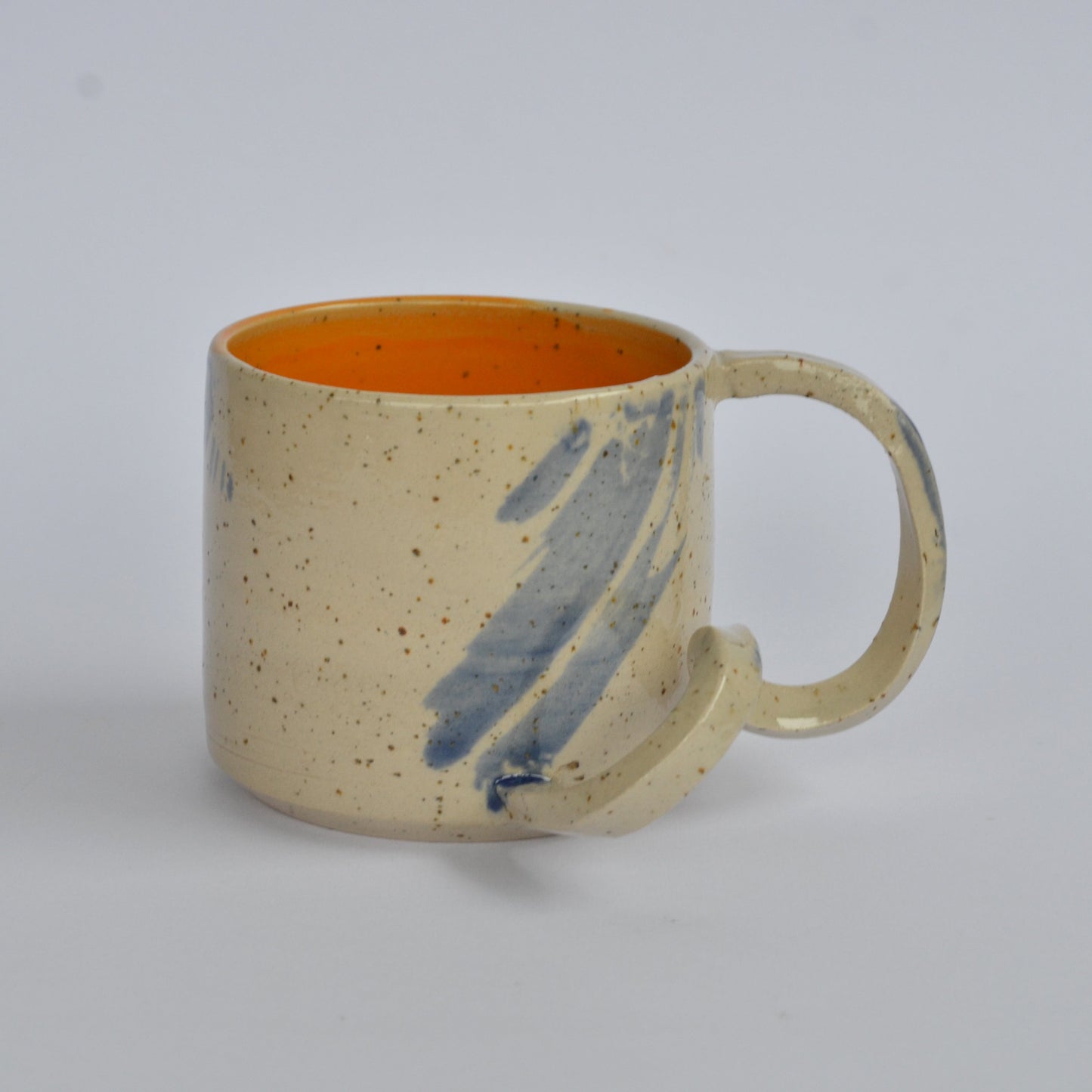 Handmade mug with a twisted handle for creative holding