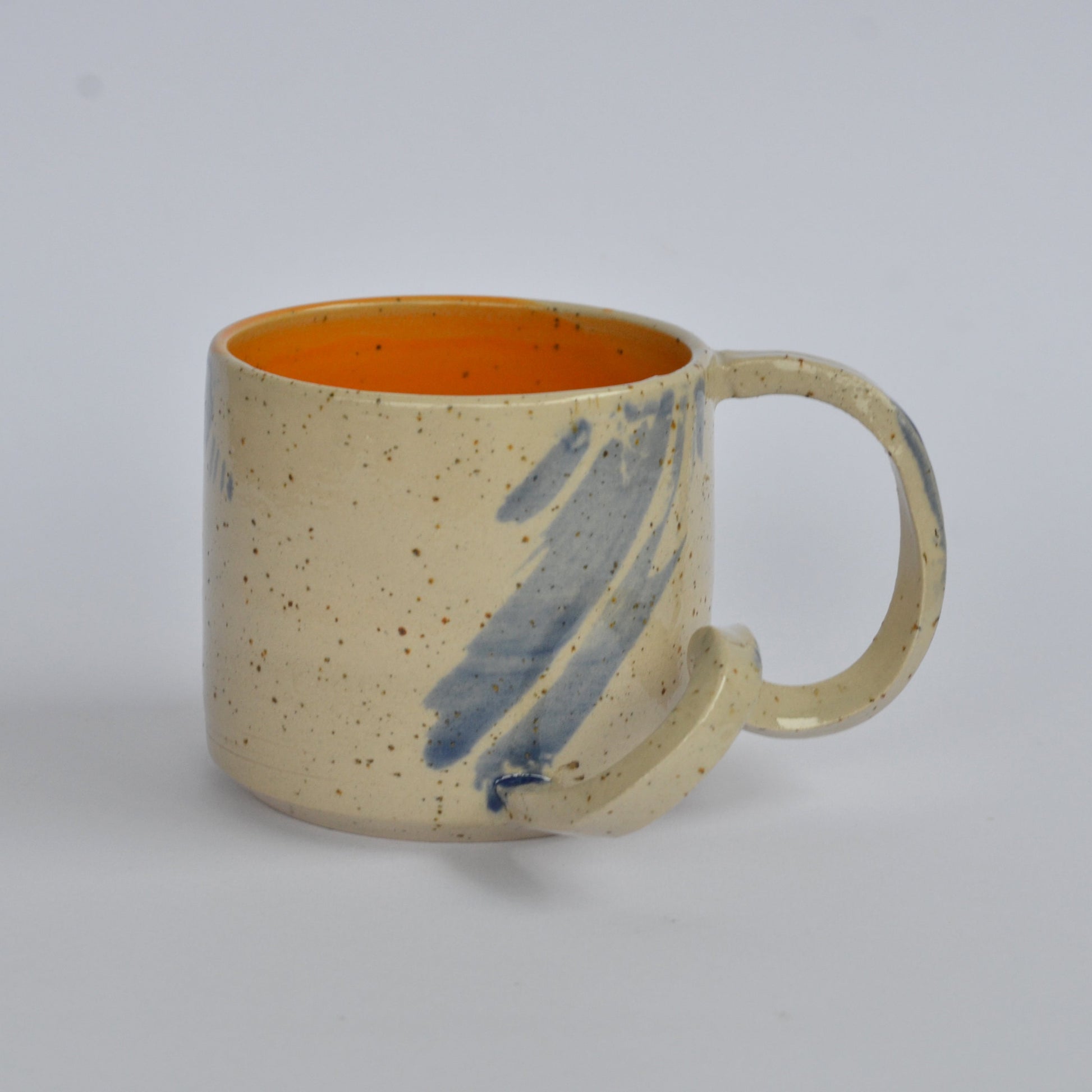 Handmade mug with a twisted handle for creative holding