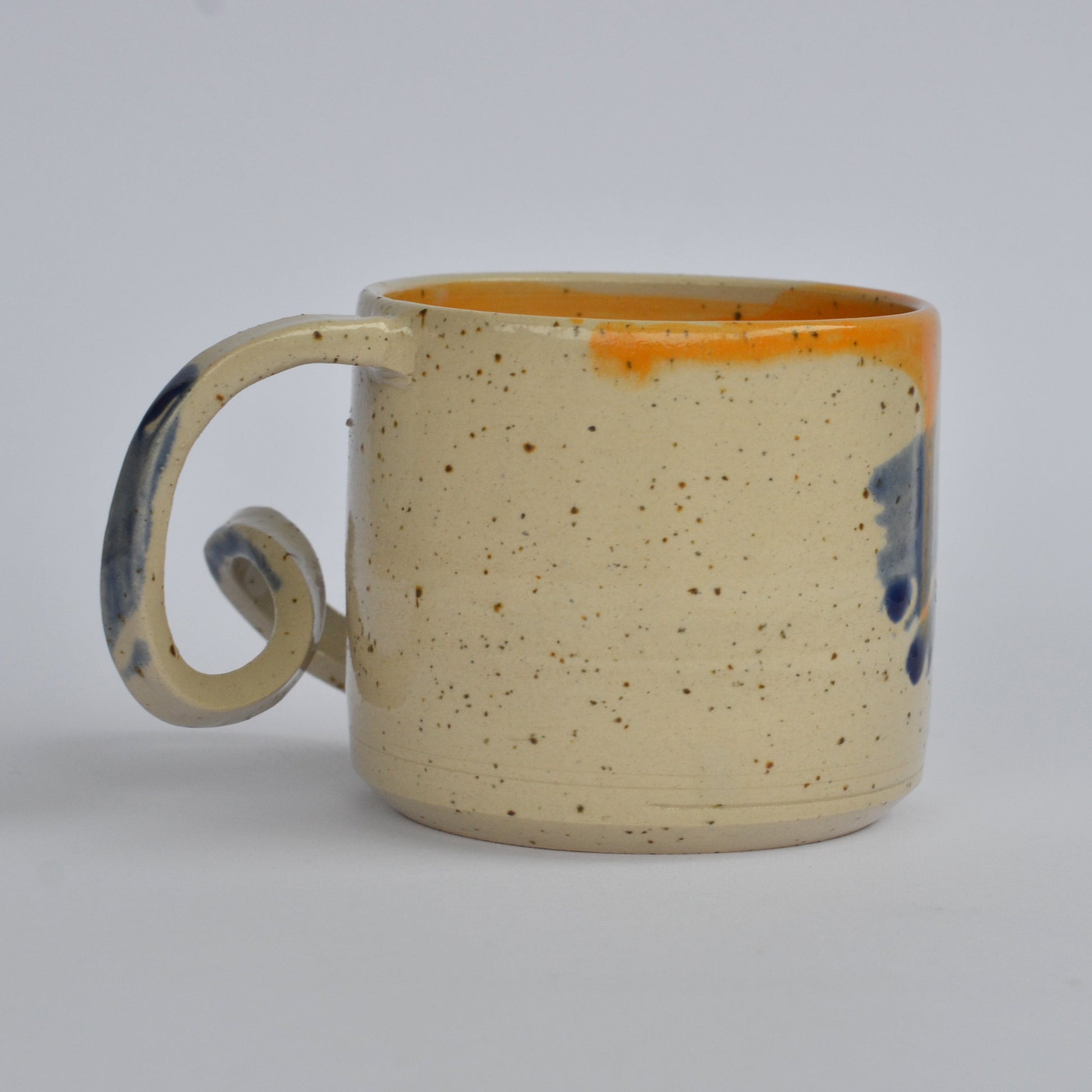 Handmade mug with a twisted handle for creative holding