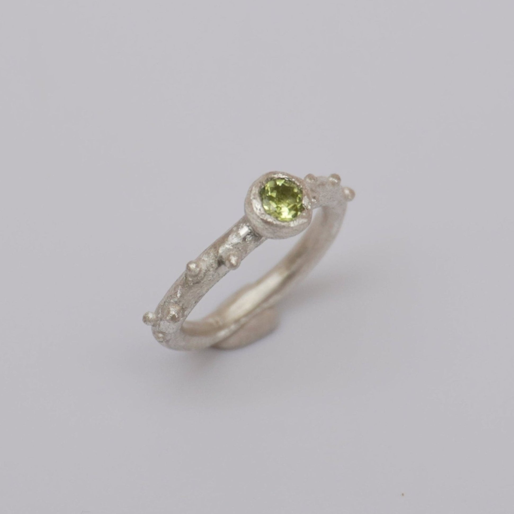  Unique handmade silver ring, featuring a 4mm natural peridot stone. Crafted from high-quality sterling silver, with intricate dot detailing