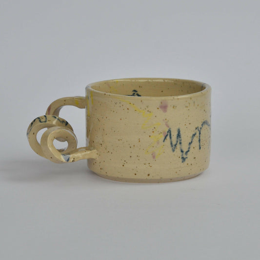 Handmade mug with a twisted handle for creative holding