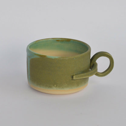 Handmade mug with a suspended handle for creative holding