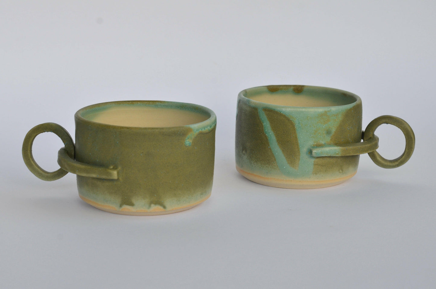 Handmade mug with a suspended handle for creative holding
